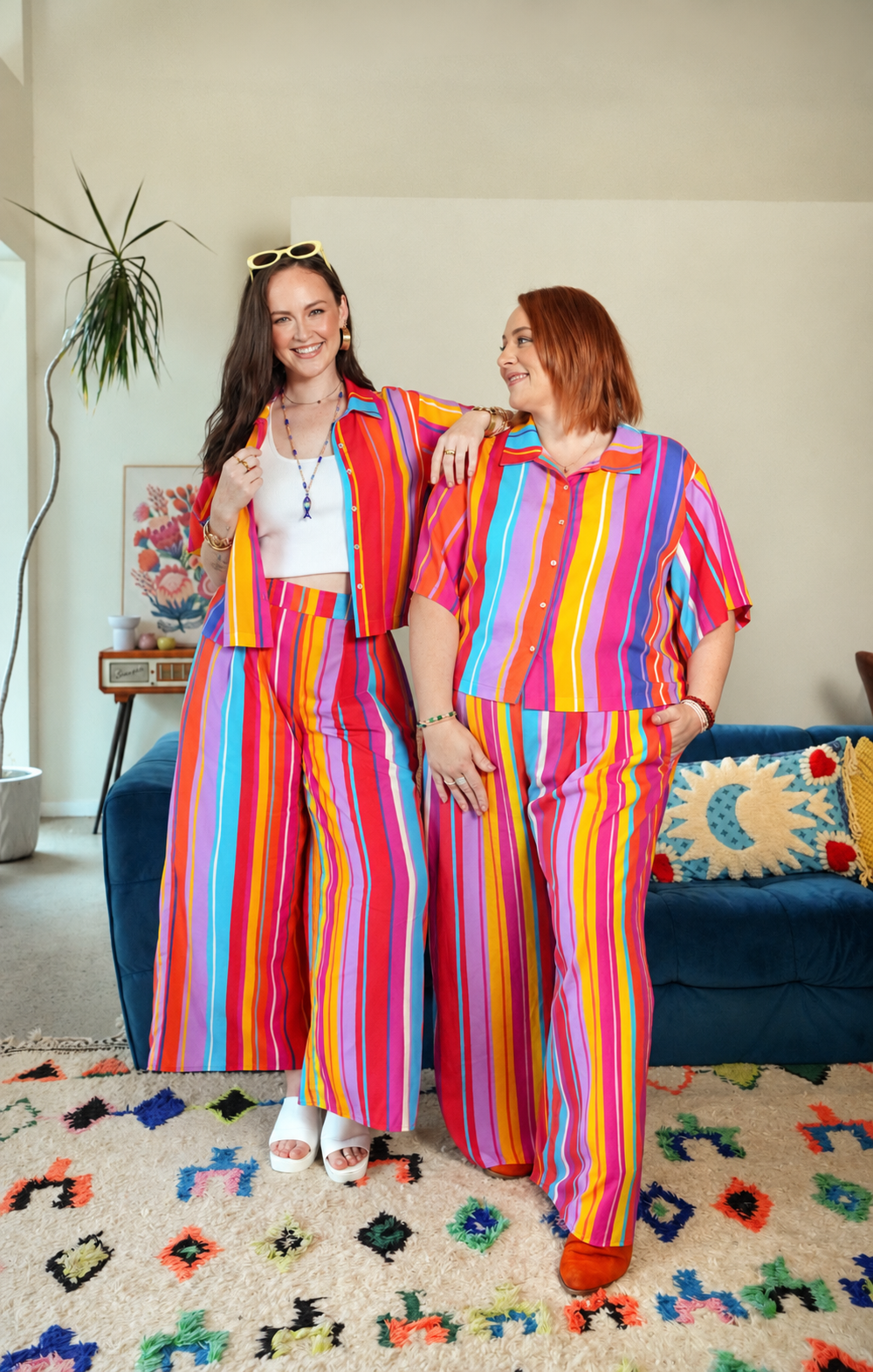 Two women in the Summer Stripe Set, Grace Top and Wide Leg Pants, in a bright living room