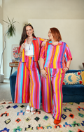Two women in the Summer Stripe Set, Grace Top and Wide Leg Pants, in a bright living room